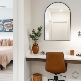 a desk with a chair and mirror