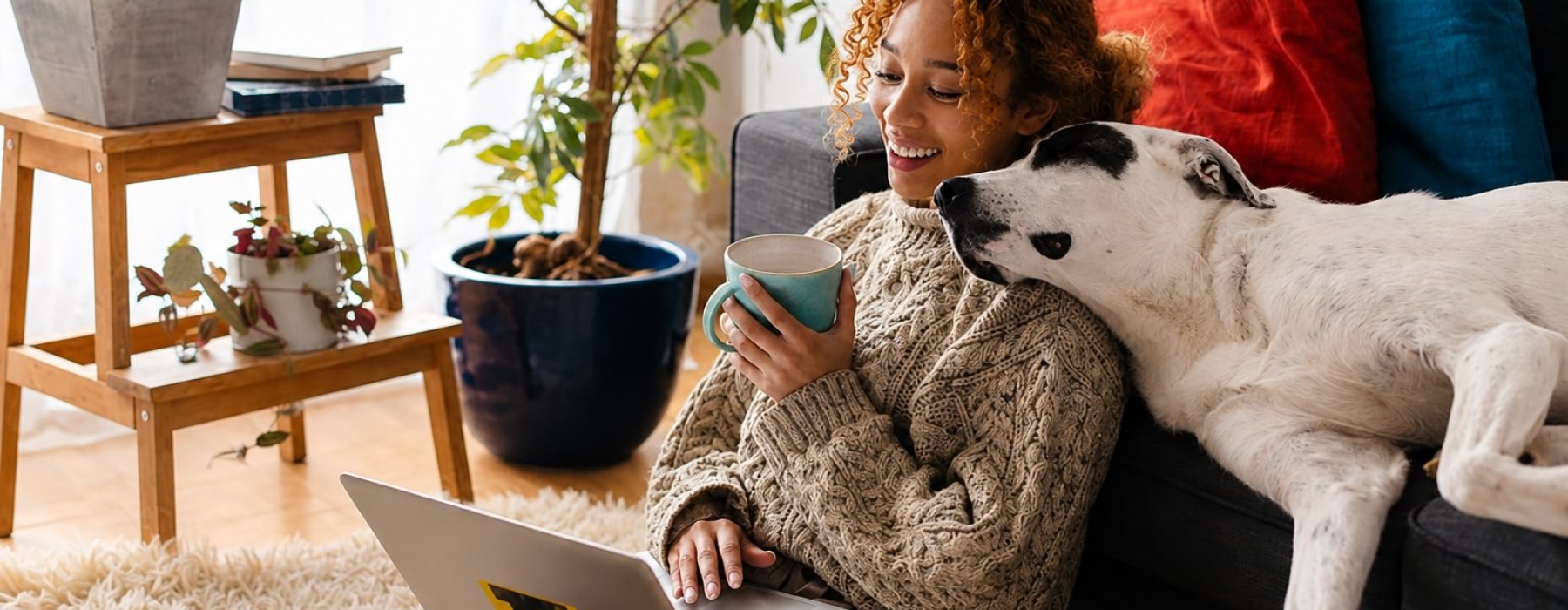 a person sitting on a couch with a dog