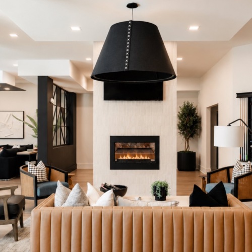 a clubroom with a couch and fireplace