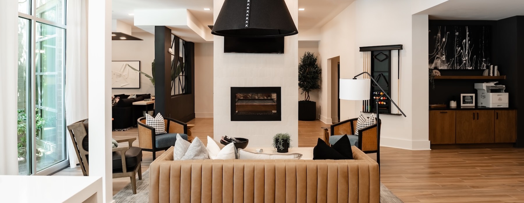 a clubroom with a couch and fireplace