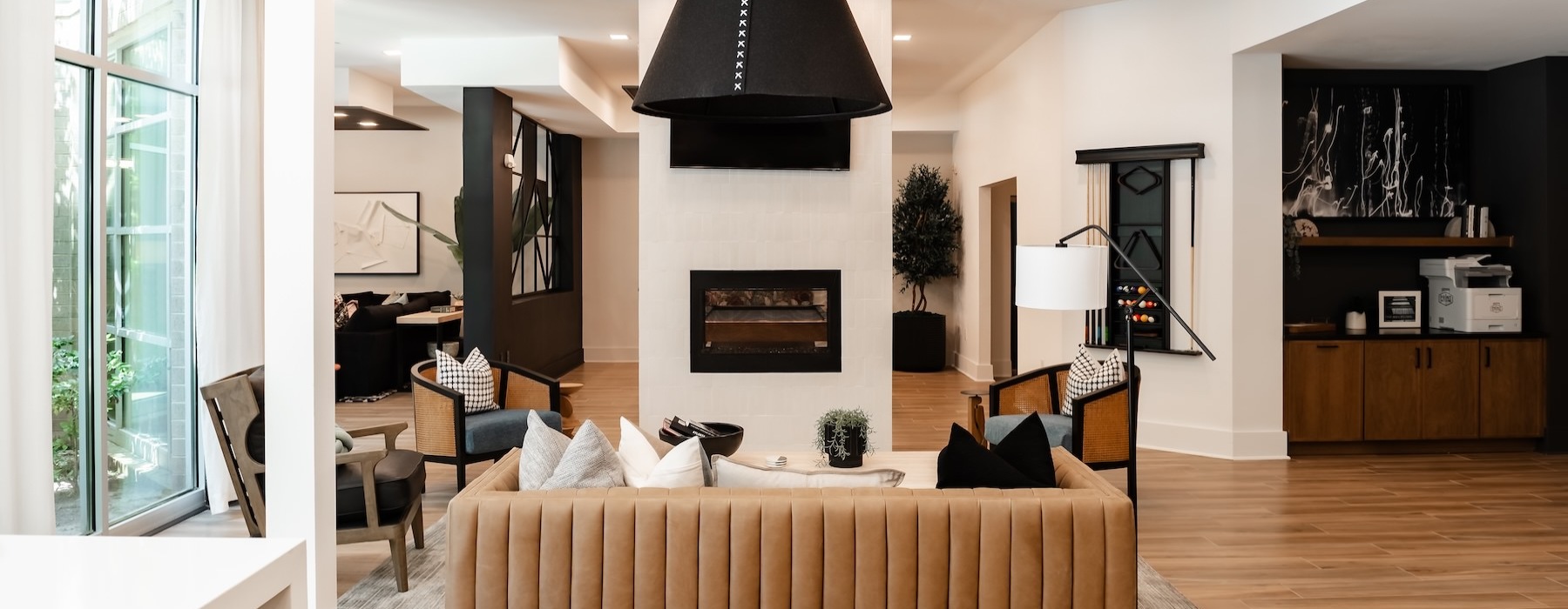 a clubroom with a couch and fireplace