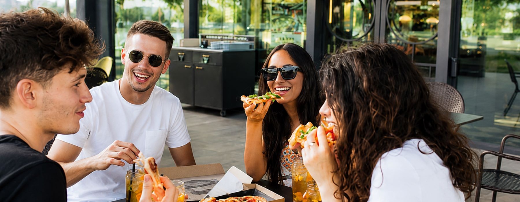 a group of people eating pizza