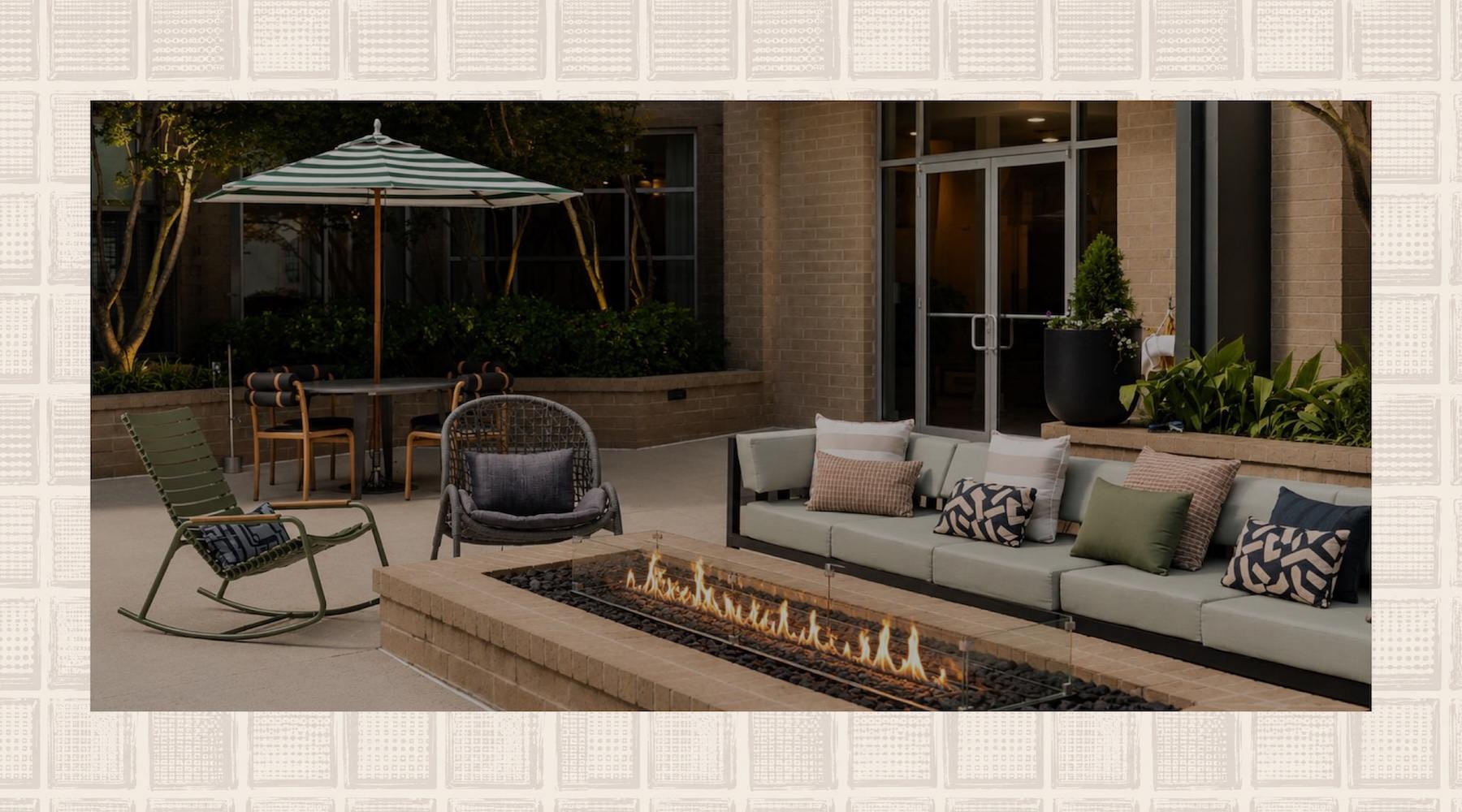 a fire pit with a couch, table and chairs